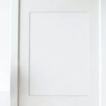 Creative Display - Empty photo frame on desk decorated with green plants