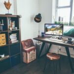 Home Workspace - two flat screen monitor turned on near organizer rack inside the room