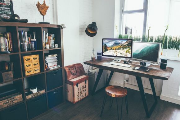 Home Workspace - two flat screen monitor turned on near organizer rack inside the room
