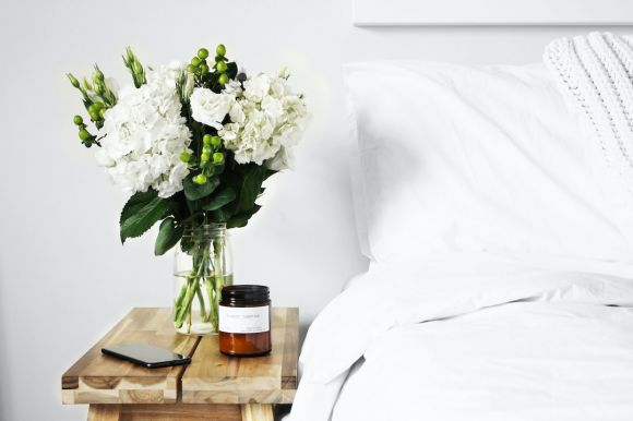 Artful Decor - flowers in clear glass vase on table