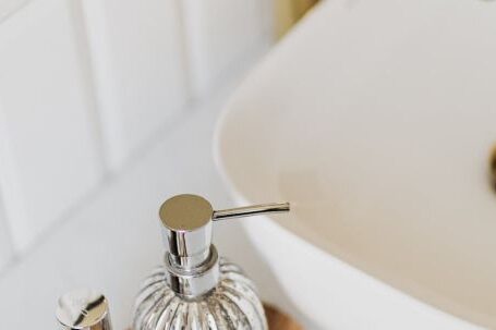 Trendy Essentials - Set of stylish cosmetic products placed near sink in bathroom