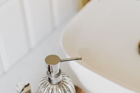 Trendy Essentials - Set of stylish cosmetic products placed near sink in bathroom