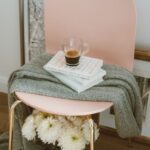 Quick Decor Tips - clear glass mug on three stacked books inside room