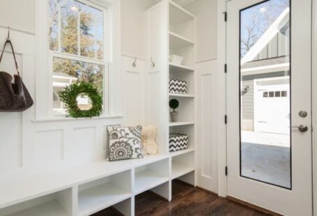 Shelves - gray and white floral throw pillow beside rack inside room