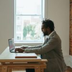 Home Office - a person sitting at a desk with a laptop and papers