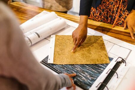 Flooring Selection. - Women Pointing Fingers on Material Samples