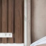 Luxury Properties - Interior of modern hotel room with bed next to bedside table under lamp hanging from ceiling