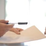 Property - Crop businessman giving contract to woman to sign