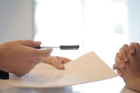 Property - Crop businessman giving contract to woman to sign