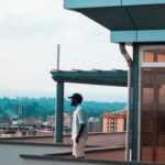Property - Man Standing on Balcony