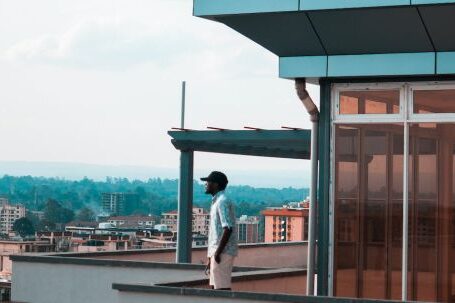 Property - Man Standing on Balcony