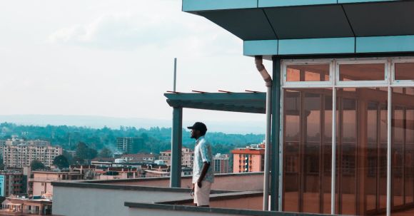 Property - Man Standing on Balcony