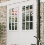 Property - Black Bicycle Parked Beside White Wooden Chair