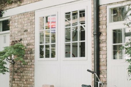 Property - Black Bicycle Parked Beside White Wooden Chair