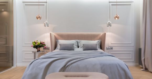 Luxury Properties - Bedroom interior with bed near table under lamps