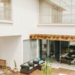 Luxury Properties - Contemporary interior of lounge area with swimming pool located on terrace of luxury villa in sunny day