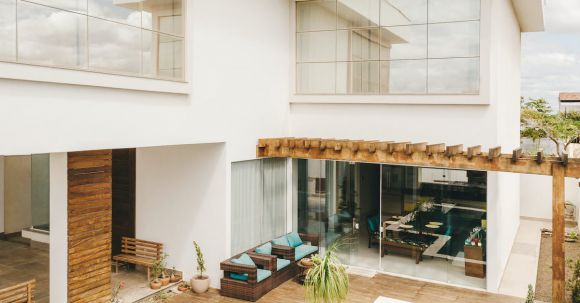 Luxury Properties - Contemporary interior of lounge area with swimming pool located on terrace of luxury villa in sunny day