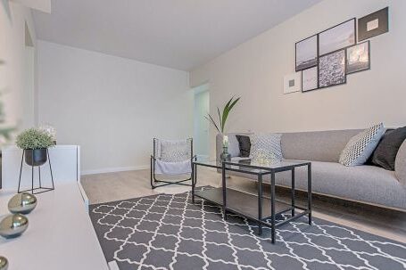 Real Estate - Three Gray Ornaments on White Wooden Desk Inside Living Room