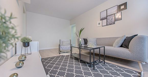 Real Estate - Three Gray Ornaments on White Wooden Desk Inside Living Room
