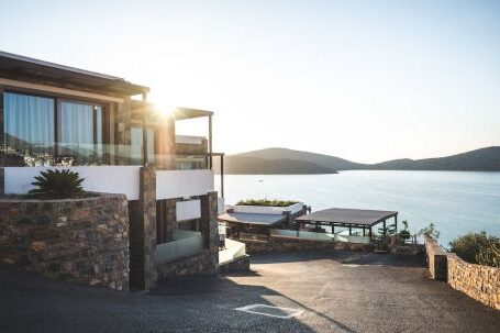 Real Estate - Sun Piercing of Brown Concrete House Near Sea