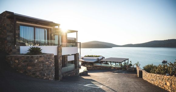 Real Estate - Sun Piercing of Brown Concrete House Near Sea