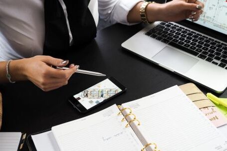 Real Estate - Person Pointing on the Screen of a Laptop