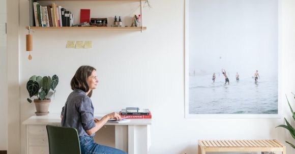 Interior Design - Woman Sitting at a Desk in a Modern Room at Home