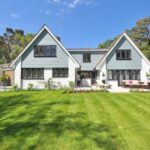 Real Estate - White and Gray Wooden House Near Grass Field and Trees