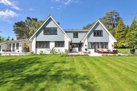 Real Estate - White and Gray Wooden House Near Grass Field and Trees