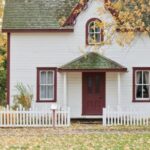 Property - White and Red Wooden House With Fence