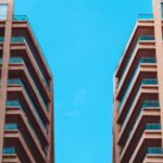Property - Low Angle View of Two High Rise Buildings Under Blue Sky