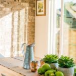 Real Estate - Black Kettle Beside Condiment Shakers and Green Fruits and Plants on Tray on Brown Wooden Table