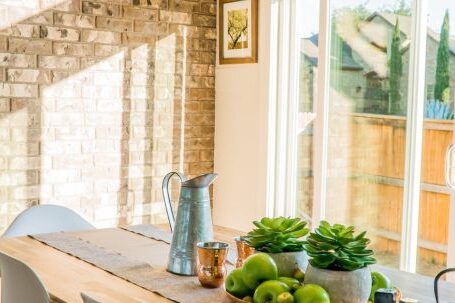 Real Estate - Black Kettle Beside Condiment Shakers and Green Fruits and Plants on Tray on Brown Wooden Table