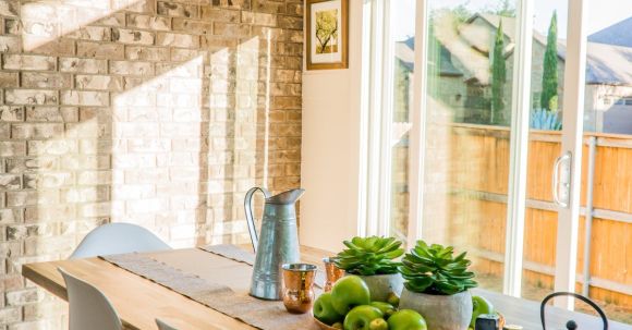 Real Estate - Black Kettle Beside Condiment Shakers and Green Fruits and Plants on Tray on Brown Wooden Table
