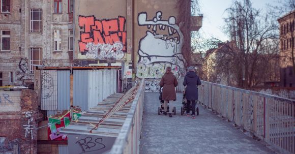 Neighborhood - Two People Walking on Bridge