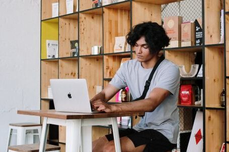 Shelvs - Man in White Crew Neck T-shirt Sitting on White Wooden Chair