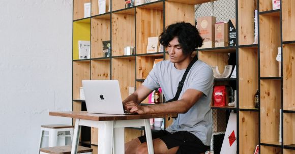 Shelvs - Man in White Crew Neck T-shirt Sitting on White Wooden Chair