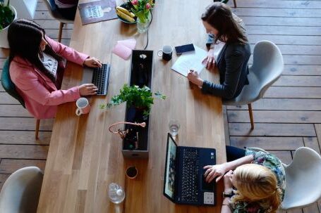 Office - Three Woman Sitting on White Chair in Front of Table