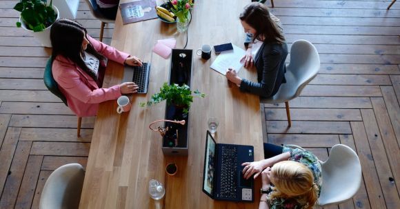 Office - Three Woman Sitting on White Chair in Front of Table
