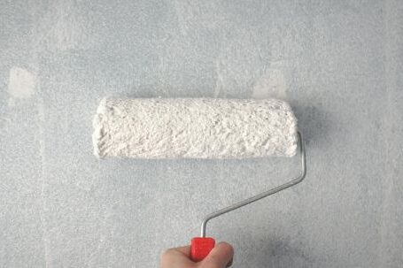 Painting Wall - Person Holding Paint Roller On Wall