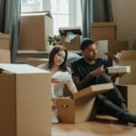 New Home - 2 Boys and Girl Sitting on Brown Cardboard Box
