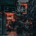 Neighborhood - City street with cars and buildings at night