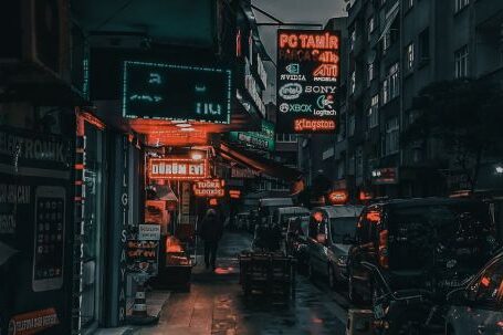 Neighborhood - City street with cars and buildings at night