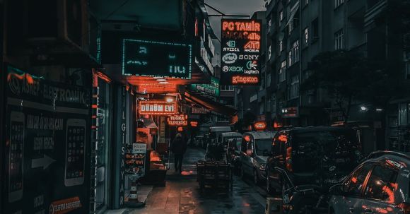 Neighborhood - City street with cars and buildings at night
