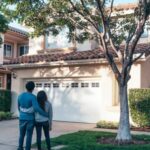 New Home - Couple Standing In Front of their House