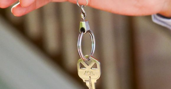 New Home - Person Holding a Keychain with Key
