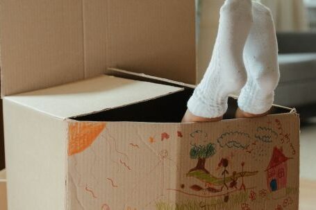 New Home - Brown Cardboard Box on Brown Wooden Table