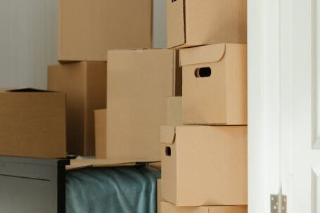 New Home - Brown Cardboard Boxes on White Wooden Drawer