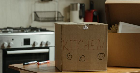 New Home - Brown Cardboard Box on White Stove Range