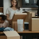 New Home - Man in Black Crew Neck T-shirt Standing Beside Woman in Gray Long Sleeve Shirt
